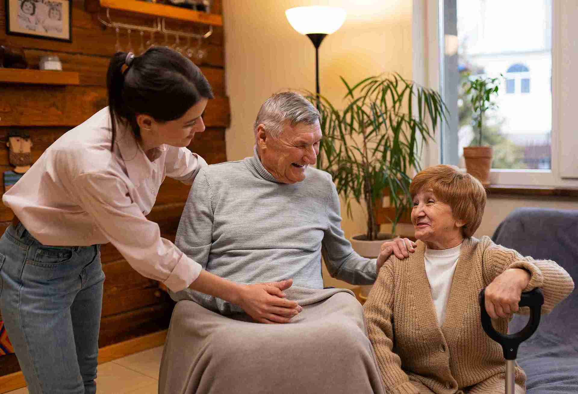 female in-home caregiver taking care of senior couple